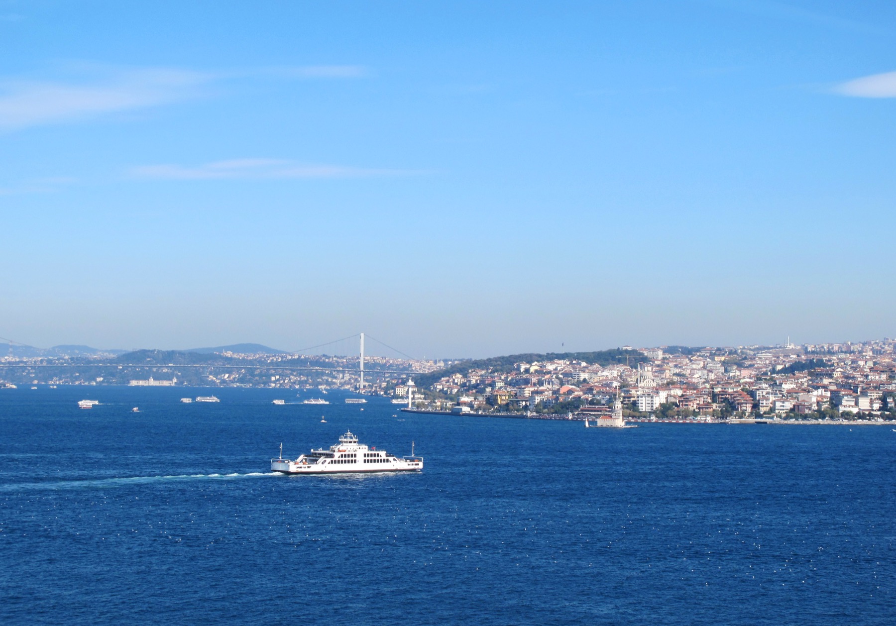 A passenger ferry crossing the Bosphorus with Istanbul in the distance